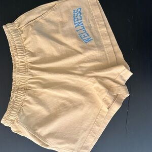 Sporty & Rich Cream Athletic Shorts with Blue Logo